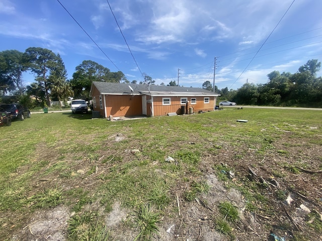 rear view of property featuring a yard