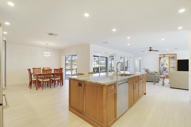 8579 SE Sabal St, Hobe Sound, FL 33455 - kitchen featuring a sink, dishwasher, light stone counters, open floor plan, and recessed lighting