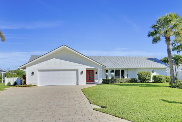 8579 SE Sabal St, Hobe Sound, FL 33455 - view of front of home with a garage and decorative driveway