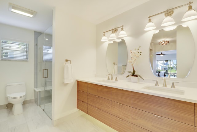 8579 SE Sabal St, Hobe Sound, FL 33455 - bathroom featuring double vanity, toilet, a stall shower, and healthy amount of natural light