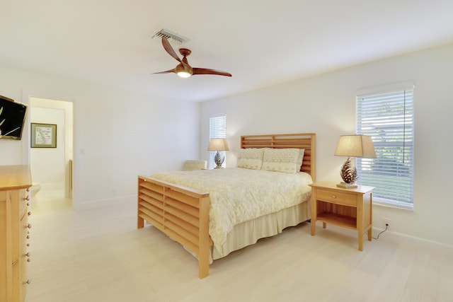 8579 SE Sabal St, Hobe Sound, FL 33455 - bedroom featuring baseboards, ceiling fan, and light floors