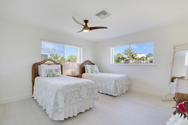 8579 SE Sabal St, Hobe Sound, FL 33455 - bedroom with baseboards, light wood finished floors, and ceiling fan