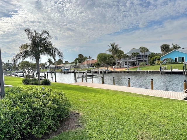 view of dock featuring a water view and a lawn