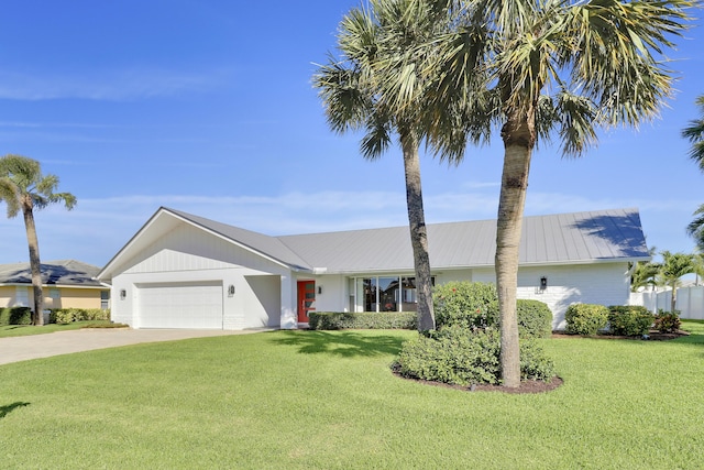 8579 SE Sabal St, Hobe Sound, FL 33455 - single story home featuring a garage, a front lawn, concrete driveway, and metal roof