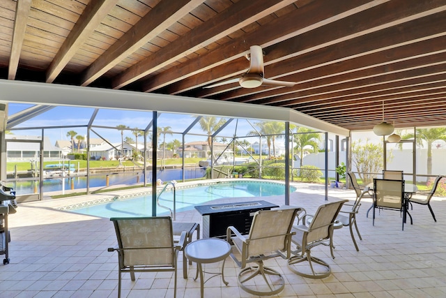 8579 SE Sabal St, Hobe Sound, FL 33455 - outdoor pool with a patio, a water view, a ceiling fan, and glass enclosure