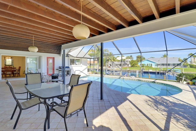 8579 SE Sabal St, Hobe Sound, FL 33455 - swimming pool with a patio, outdoor dining space, a water view, and glass enclosure
