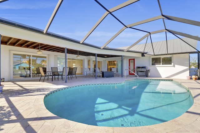 8579 SE Sabal St, Hobe Sound, FL 33455 - outdoor pool featuring a patio, area for grilling, outdoor dining space, glass enclosure, and an outdoor living space