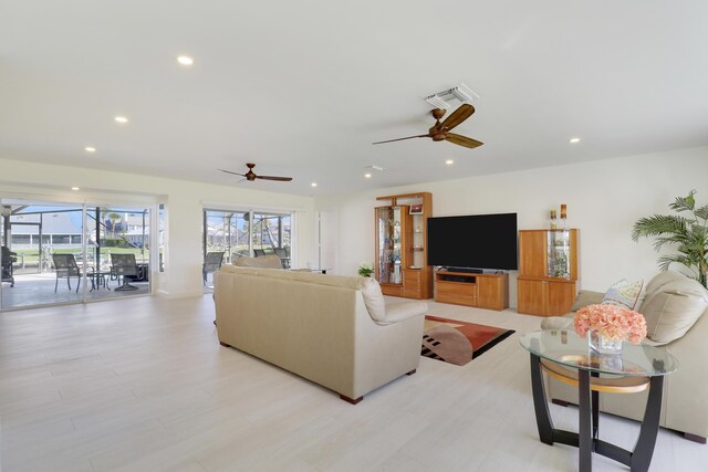 8579 SE Sabal St, Hobe Sound, FL 33455 - living area featuring a ceiling fan, recessed lighting, and light wood-style flooring