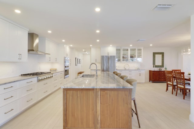 8579 SE Sabal St, Hobe Sound, FL 33455 - kitchen with wall chimney exhaust hood, a sink, appliances with stainless steel finishes, white cabinetry, and recessed lighting
