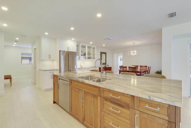 8579 SE Sabal St, Hobe Sound, FL 33455 - kitchen with a sink, stainless steel appliances, recessed lighting, glass insert cabinets, and light stone countertops