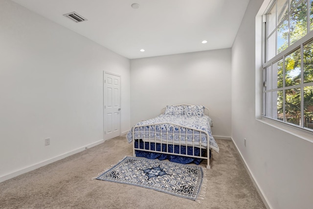 carpeted bedroom featuring recessed lighting, baseboards, and visible vents