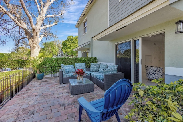 view of patio featuring an outdoor living space and fence