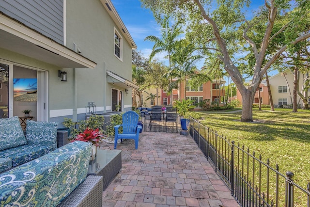 exterior space featuring a patio area, a lawn, and outdoor lounge area