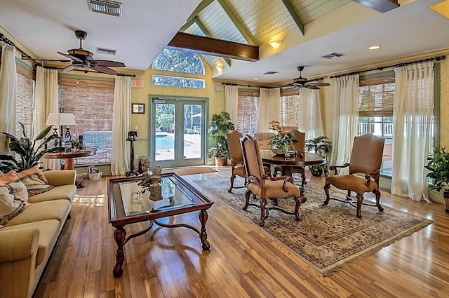 interior space featuring visible vents, beamed ceiling, french doors, and hardwood / wood-style flooring