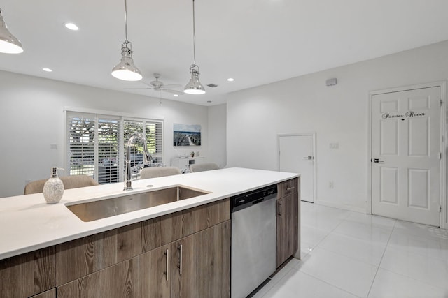 kitchen with a sink, stainless steel dishwasher, recessed lighting, and light countertops