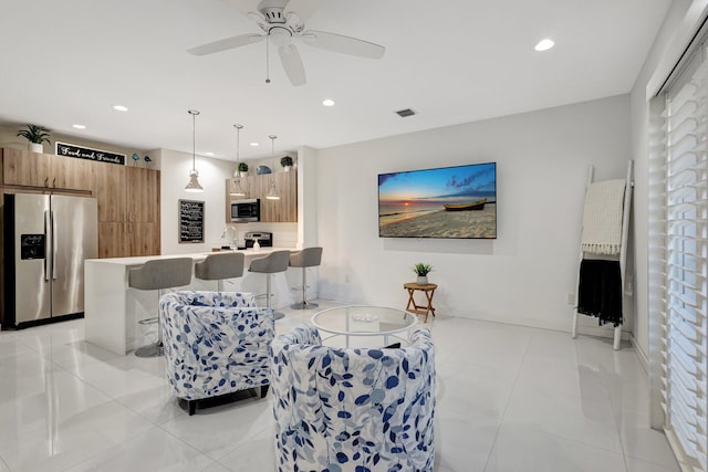 living area with light tile patterned floors, recessed lighting, and ceiling fan