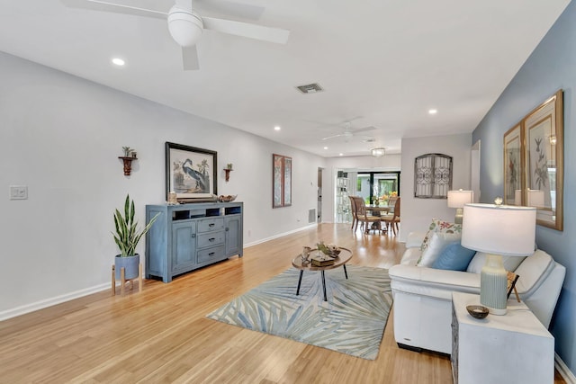 living room featuring recessed lighting, baseboards, visible vents, and light wood finished floors