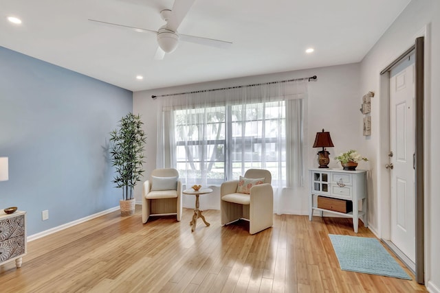 living area featuring ceiling fan, recessed lighting, wood finished floors, and baseboards