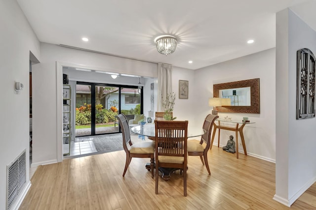 dining room with recessed lighting, visible vents, light wood-style flooring, and baseboards