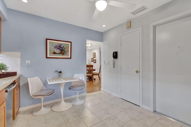 interior space featuring ceiling fan, visible vents, baseboards, and light tile patterned flooring