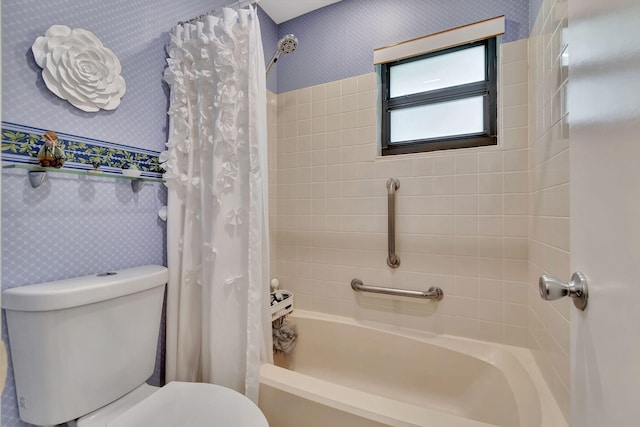 full bathroom with toilet, wallpapered walls, and shower / tub combo with curtain