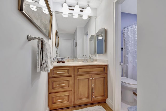 bathroom with toilet, a shower with curtain, and vanity