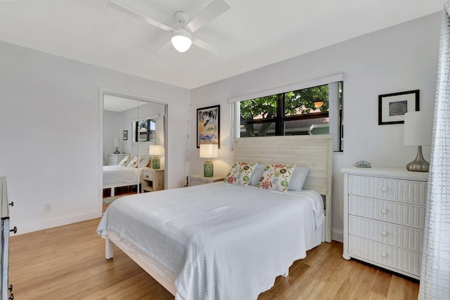 bedroom with a ceiling fan, baseboards, and wood finished floors