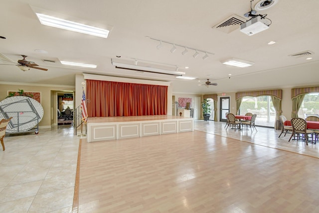interior space with ceiling fan, crown molding, visible vents, and baseboards