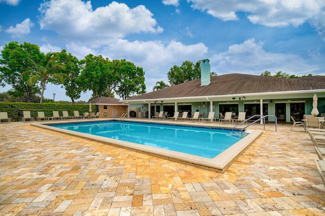 community pool with a patio area