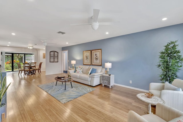 living room with recessed lighting, visible vents, baseboards, a ceiling fan, and light wood finished floors