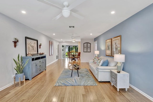 living area with visible vents, ceiling fan, recessed lighting, and light wood-style flooring