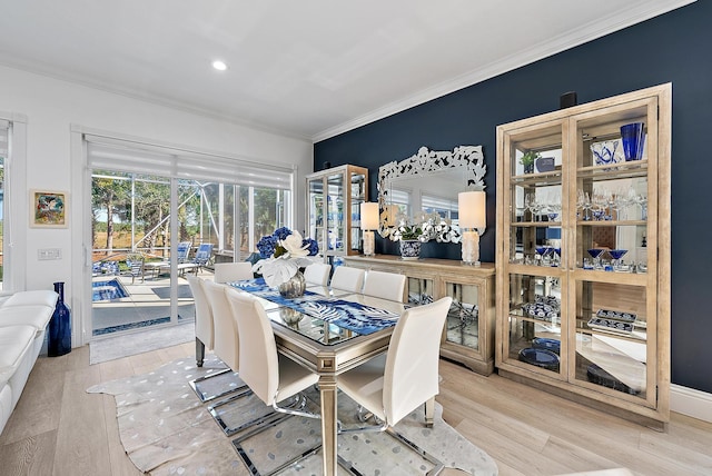 dining room with recessed lighting, wood finished floors, a sunroom, and ornamental molding