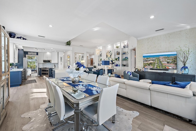 dining space featuring recessed lighting, light wood-style flooring, crown molding, and visible vents