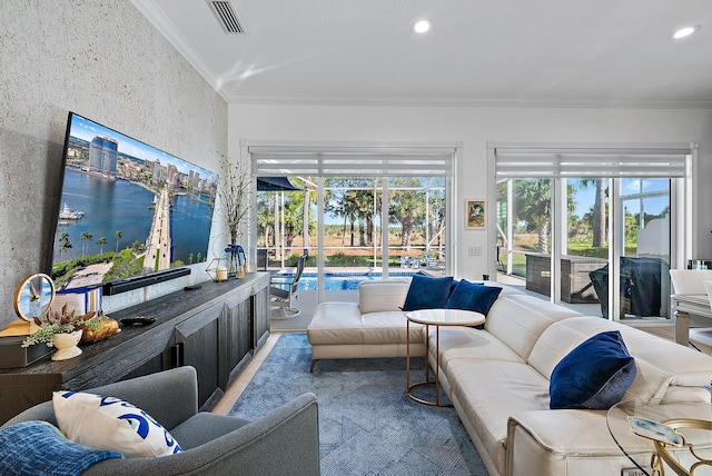 living room with recessed lighting, a healthy amount of sunlight, and ornamental molding