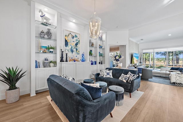 living area featuring baseboards, built in shelves, light wood-style flooring, and ornamental molding