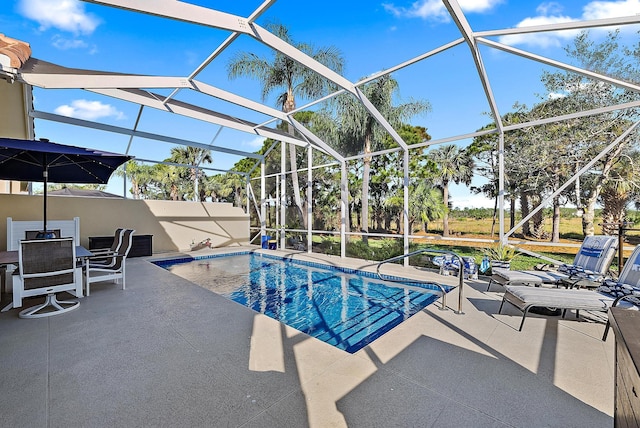 outdoor pool with a lanai, outdoor dining space, and a patio area