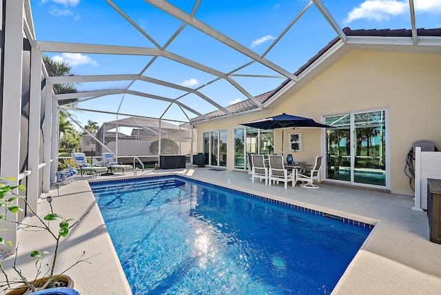 pool featuring glass enclosure and a patio