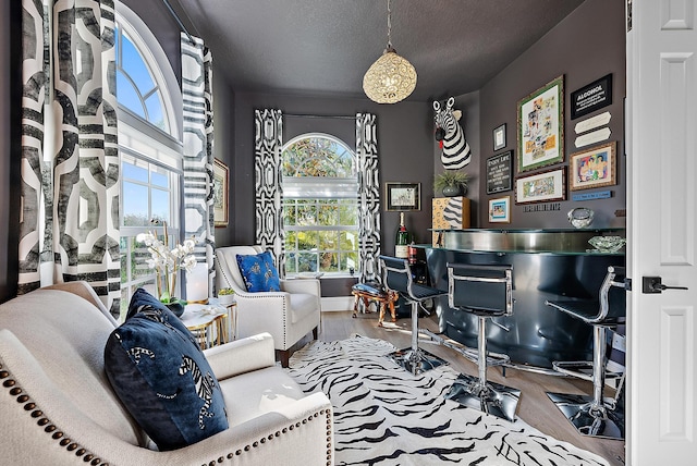 home office featuring wood finished floors and a textured ceiling