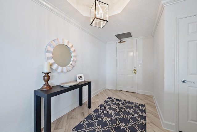 entryway featuring ornamental molding, wood finished floors, and baseboards