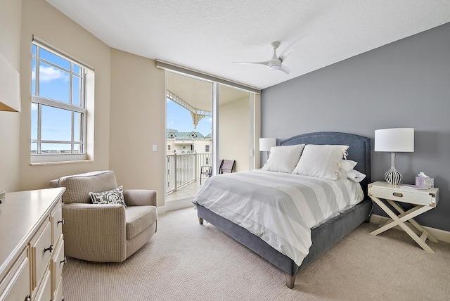 bedroom with light carpet, access to exterior, a ceiling fan, and a textured ceiling