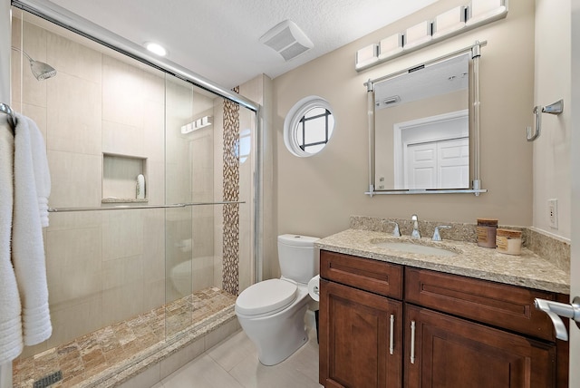 bathroom featuring visible vents, toilet, a shower stall, vanity, and tile patterned floors