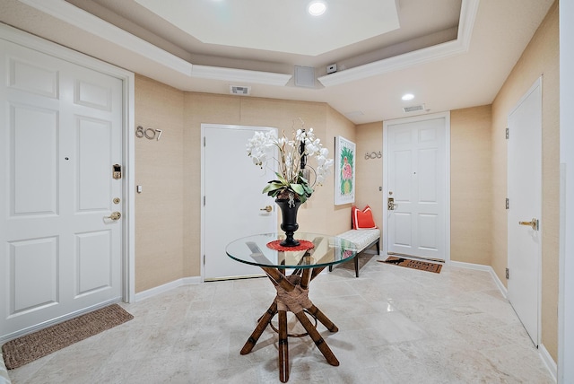 foyer with baseboards, a tray ceiling, visible vents, and recessed lighting