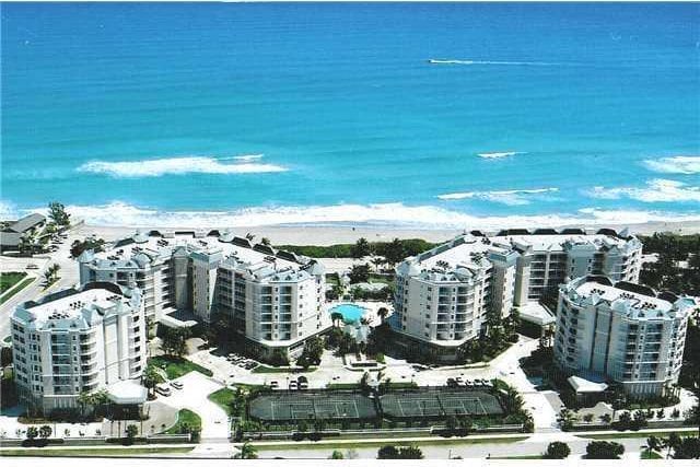 birds eye view of property with a water view and a view of city