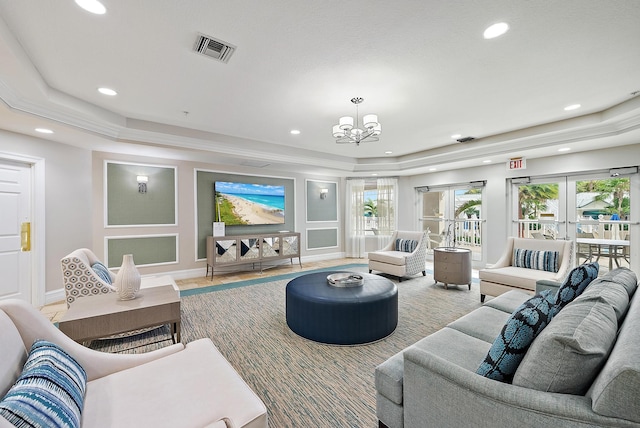 living room with a chandelier, recessed lighting, a raised ceiling, and visible vents