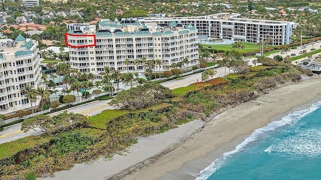 view of property featuring a water view and a view of the beach