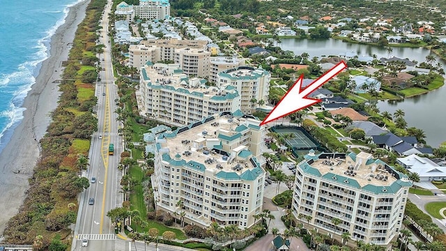 aerial view featuring a water view, a view of city, and a view of the beach