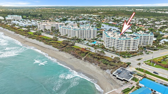 aerial view with a view of the beach, a water view, and a city view