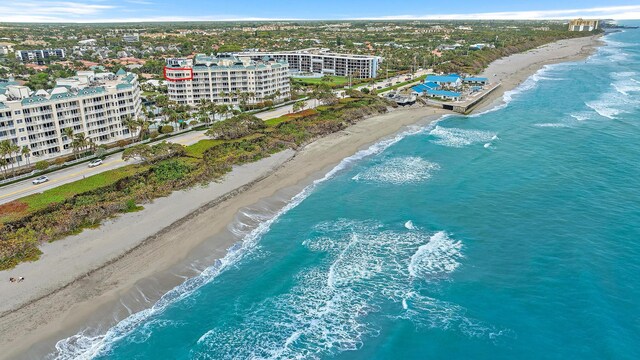 birds eye view of property featuring a view of the beach, a water view, and a city view