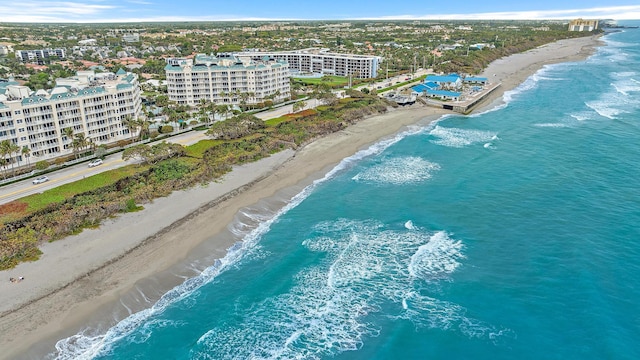 birds eye view of property with a view of city, a beach view, and a water view