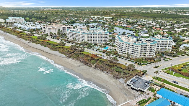 aerial view featuring a view of city, a beach view, and a water view